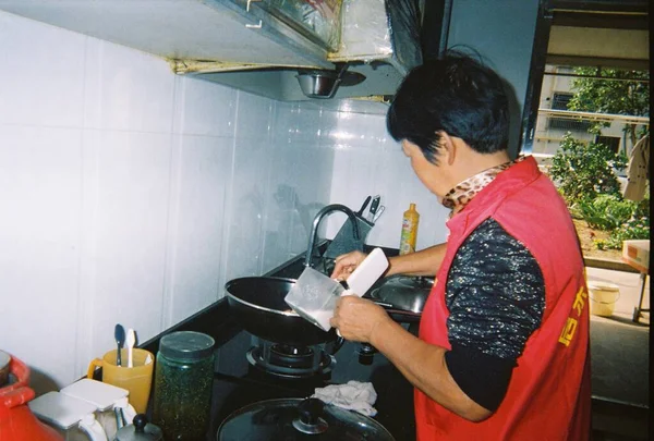 man cooking food in kitchen