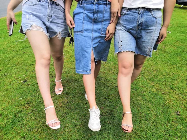 young couple in green dress and jeans on the grass