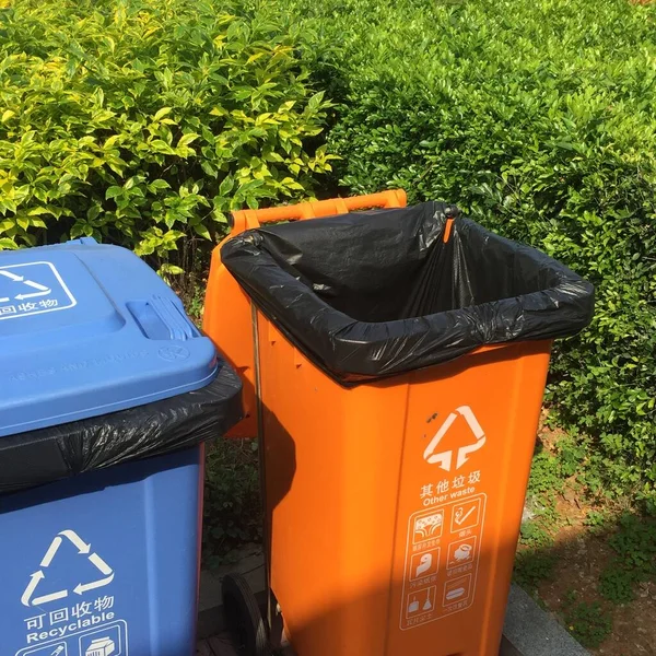 green garbage bin in the park