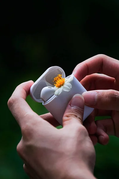 close up of a hand holding a flower