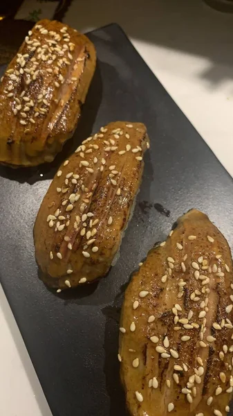 homemade buns with sesame seeds and cheese on a white plate