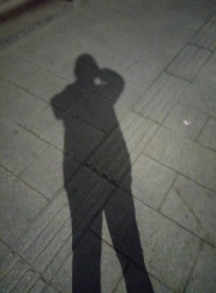 silhouette of a man in a suit walking on the street