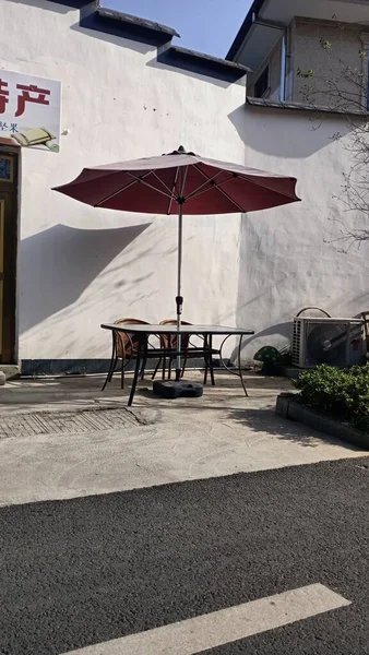 street cafe with a bench and a umbrella