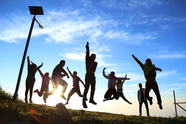 group of people jumping on the beach