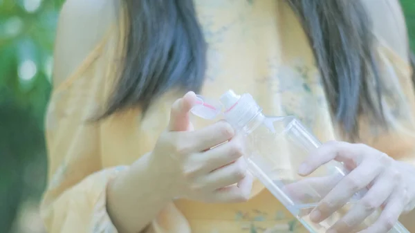 woman drinking water from bottle of milk in the morning.