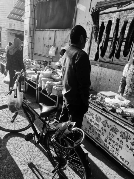 black and white photo of a man in a street