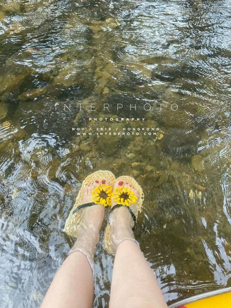 woman's feet in a puddle on the beach