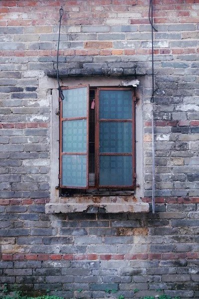 old brick wall with a window