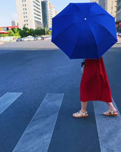 young woman with umbrella on the street