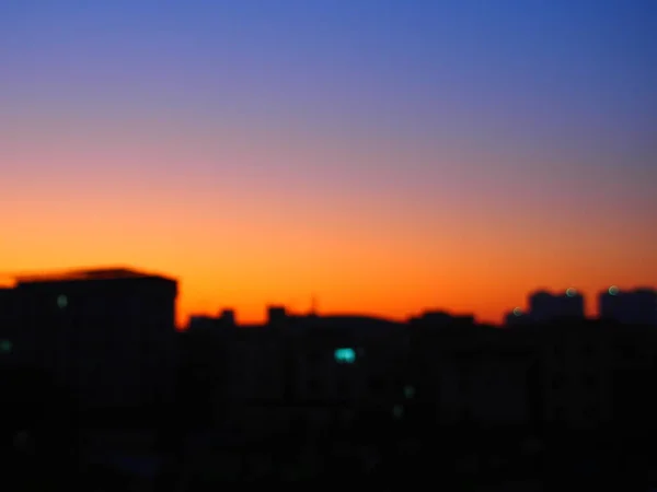 blurred background of city skyline at sunset