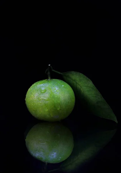 green apple with leaf on black background