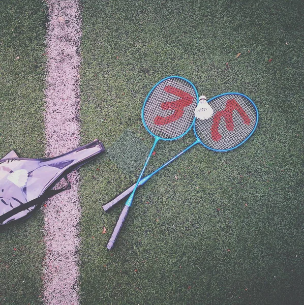 tennis racket and ball on the ground