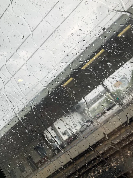 car window with rain drops on the glass