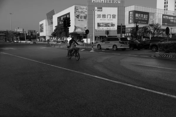 black and white photo of a street in the city