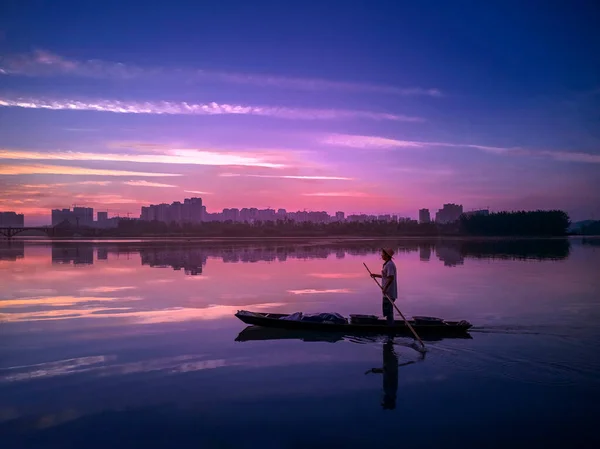 silhouette of a man on the lake