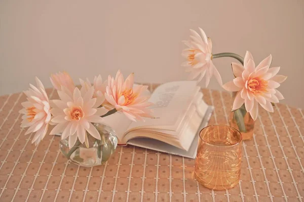 book and flowers on a table