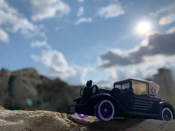 a small toy car on the beach