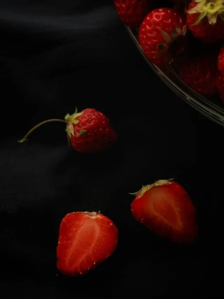 fresh ripe strawberries on black background