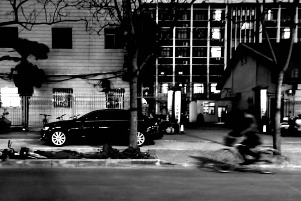 black and white photo of a street in the city