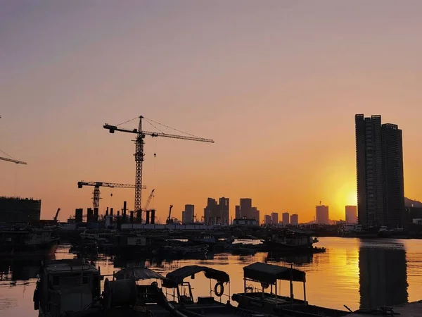 construction cranes and crane at sunset