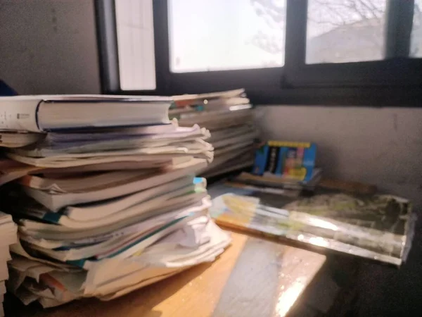 stack of books and documents on the table
