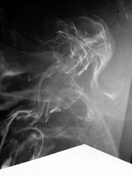 black and white smoke on a dark background