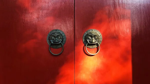 red chinese door knocker on wooden background