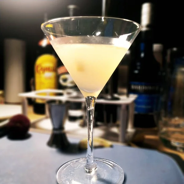 cocktail with a glass of water and a martini bar