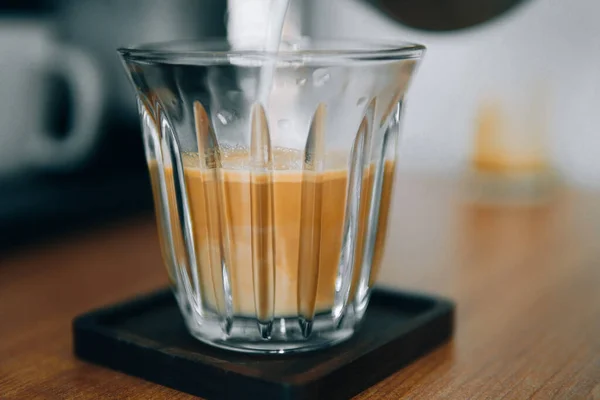 iced coffee in glass on wooden table