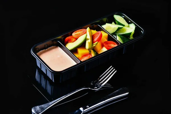 fresh vegetables in a box on a black background
