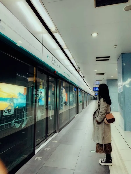 young woman in a subway train station