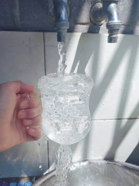 pouring water from a glass of beer