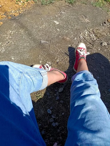 feet of a woman's legs on the pavement