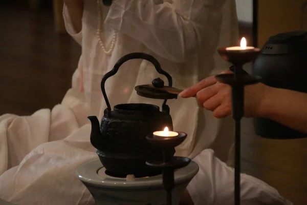 candle in the hands of a woman in a hand