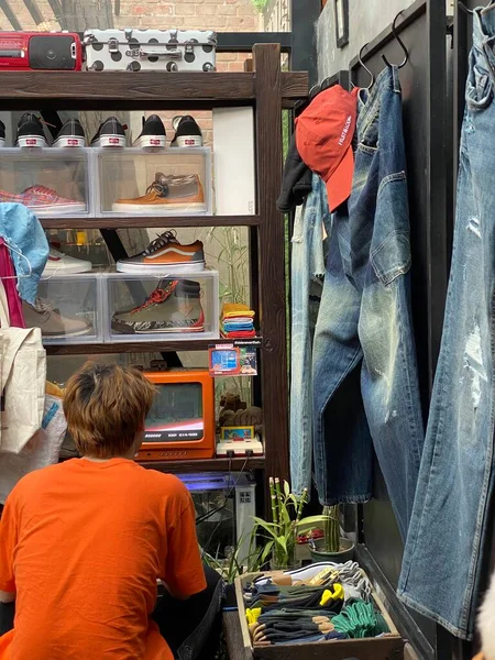 man in a shop with a bag of coffee