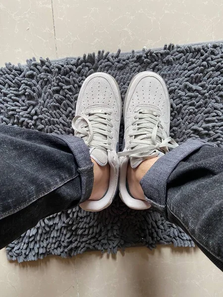 feet of a woman\'s shoes on a gray background