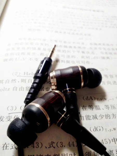 close up of a book with a pen and a stethoscope