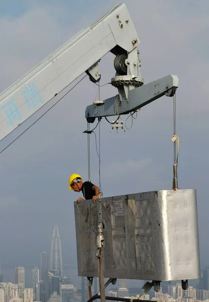 construction worker with crane and building