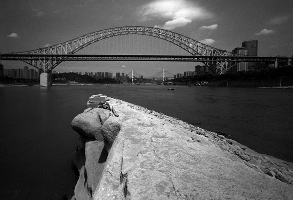 black and white image of the bridge over the river