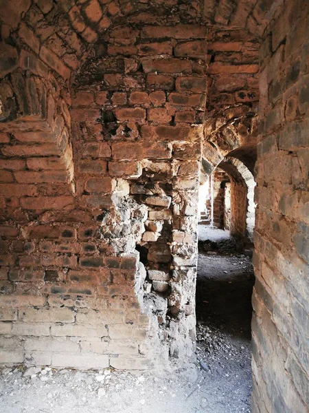 old abandoned brick wall with a large window