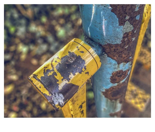 old rusty metal sign on the road