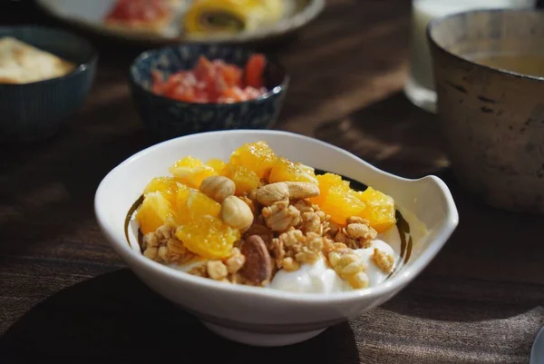 breakfast with a bowl of corn, nuts, walnuts, orange juice, healthy food