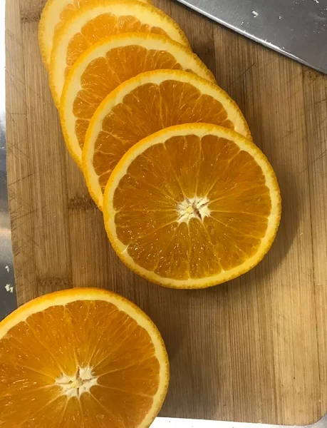 fresh sliced orange slices on wooden background