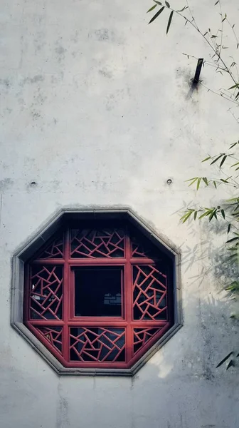 old wooden window with a red and white wall
