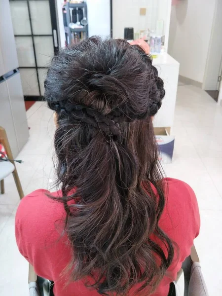 woman hairdresser with hair dryer in the salon