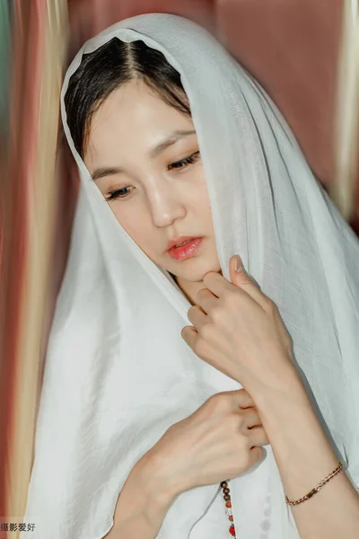 portrait of a beautiful young woman with a veil on her face