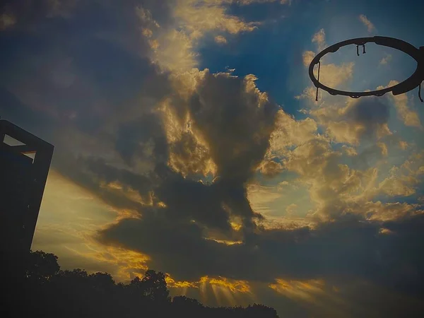 silhouette of a flying basketball ball on the sky