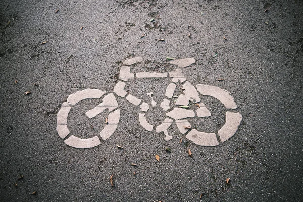 bicycle sign on asphalt road