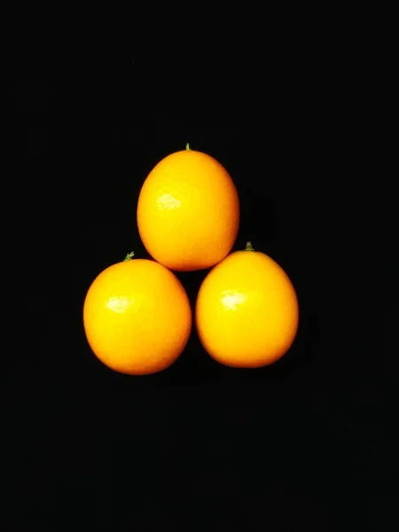 yellow and black-orange fruit on a dark background
