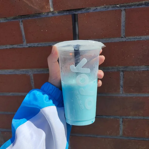 hand holding a bucket with a water bottle